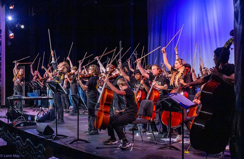 Orchestra students perform onstage